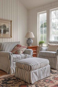 a living room with striped chairs and ottomans