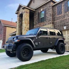 a black jeep parked in front of a house