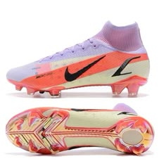 a pair of soccer shoes with pink and orange accents