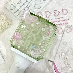 a hair dryer sitting on top of a table next to some beads and other items