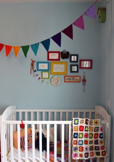 a baby's crib is decorated with colorful flags