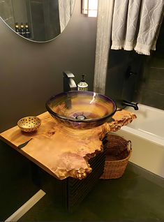 a bathroom sink sitting on top of a wooden table