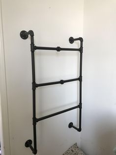 an old fashioned black metal towel rack in a bathroom