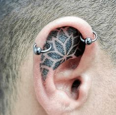 a man with a tattoo on his ear