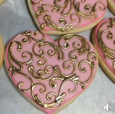 pink and gold heart shaped cookies with swirls on them are ready to be decorated