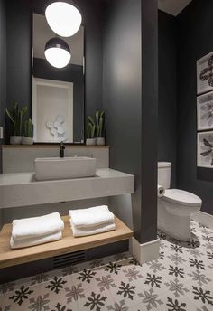 a bathroom with black walls and white fixtures