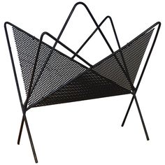 a black metal magazine rack with three sections on each side and one section in the shape of a triangle