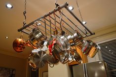 pots and pans are hanging from the ceiling