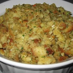 a white bowl filled with food on top of a stove