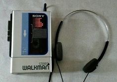 an old style walkman with headphones attached to it