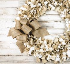 a wreath made out of burlocks on a wooden surface