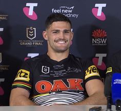 a man sitting in front of a microphone at a press conference