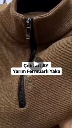 a person holding up a brown sweater with the words, cok olay yam fermurari yaka on it