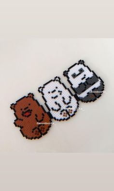 two cross stitch stickers with different characters on them