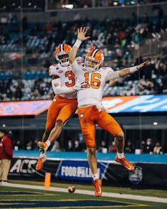 two football players jumping up in the air