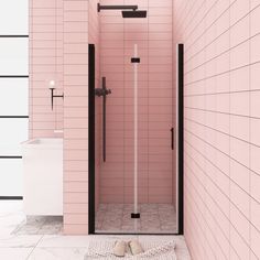 a bathroom with pink walls and tiled floors, including a shower stall in the middle