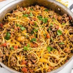 a skillet filled with spaghetti and meat