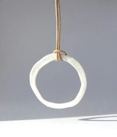 a white circle hanging from a rope