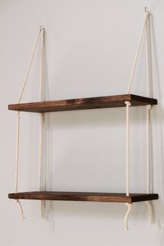 two wooden shelves with rope hanging from them