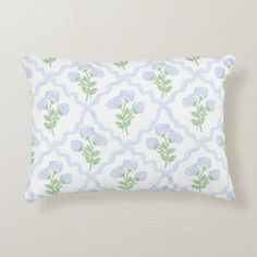 a blue and white pillow with flowers on it