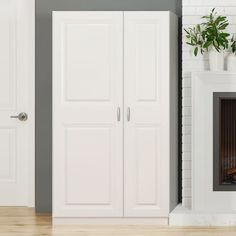 a white fireplace with two doors and a potted plant on the mantel next to it