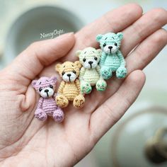 small crocheted teddy bears are held in someone's hand