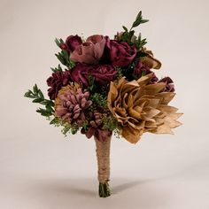 a bridal bouquet with purple and red flowers