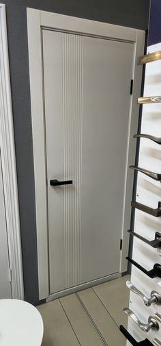 a white door with black handles in a room