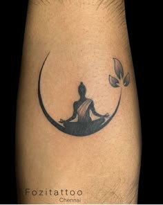 a person sitting in the middle of a crescent tattoo