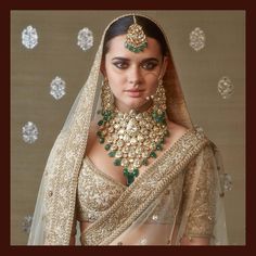 a woman wearing a bridal outfit and jewelry