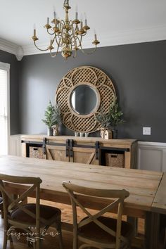 a dining room table with chairs and a chandelier