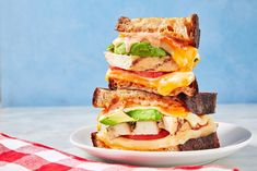 a stack of grilled sandwiches sitting on top of a white plate