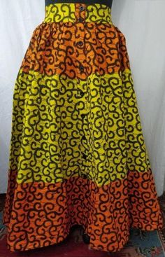 African Print Button Down Maxi Skirt Colors: Black/White, Blue/Gold, Geometric, Orange/Multi, Multi, Pink/Blue, Red/Yellow, Yellow/Orange Size: One size fit All (up to size 3X) GROUP ORDERS AVAILABLE Multicolor Buttoned Skirt For Spring, Fitted Orange Cotton Skirt, Orange Fitted Cotton Skirt, Button Down Maxi Skirt, Tailoring Ideas, Best African Dresses, African Fashion Ankara, African Print Dress, African Print Dresses