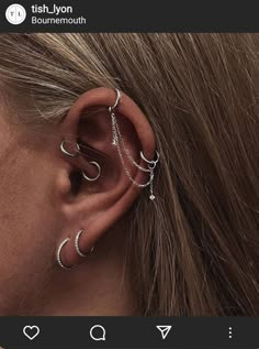 a woman's ear is shown with three different piercings