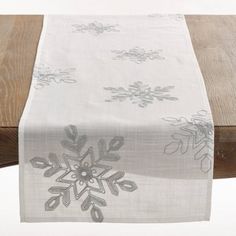 the table runner has snowflakes on it