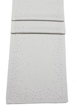 a white sheet with silver sequins on the bottom and one side is folded