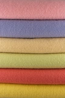 several different colored towels stacked on top of each other