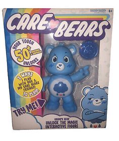 the care bears toy is in its box with it's blue plastic bear figure