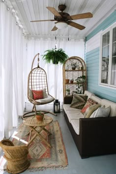 a porch with two hanging chairs and a hammock