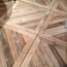 the floor is made out of wood planks and has an interesting pattern on it