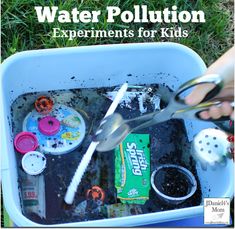 a child's hands holding scissors over an empty container filled with water pollution experiments for kids