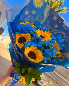 a bouquet of sunflowers wrapped in blue paper