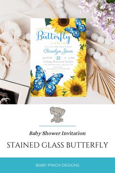 a baby shower party with sunflowers and blue butterflies on the front, and an elephant in the back