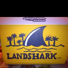 a yellow and blue lunch box with the words landshark on it's side