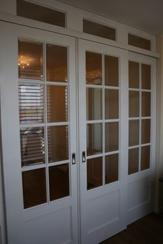 two white double doors with glass panes on each side