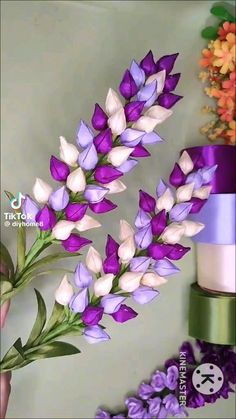 purple and white flowers in front of a cake