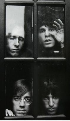 the beatles looking through four windows in black and white