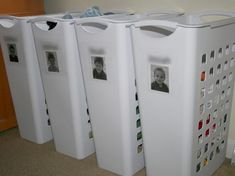 three white storage bins with pictures on them