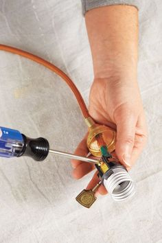 a person is holding a hose connected to an outlet