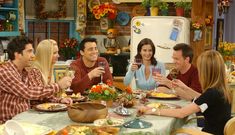 a group of people sitting around a table eating food